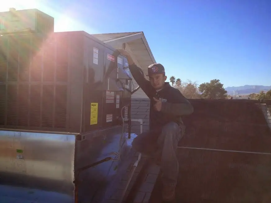HVAC technician performing Boiler Repair on a rooftop unit in Twinsburg